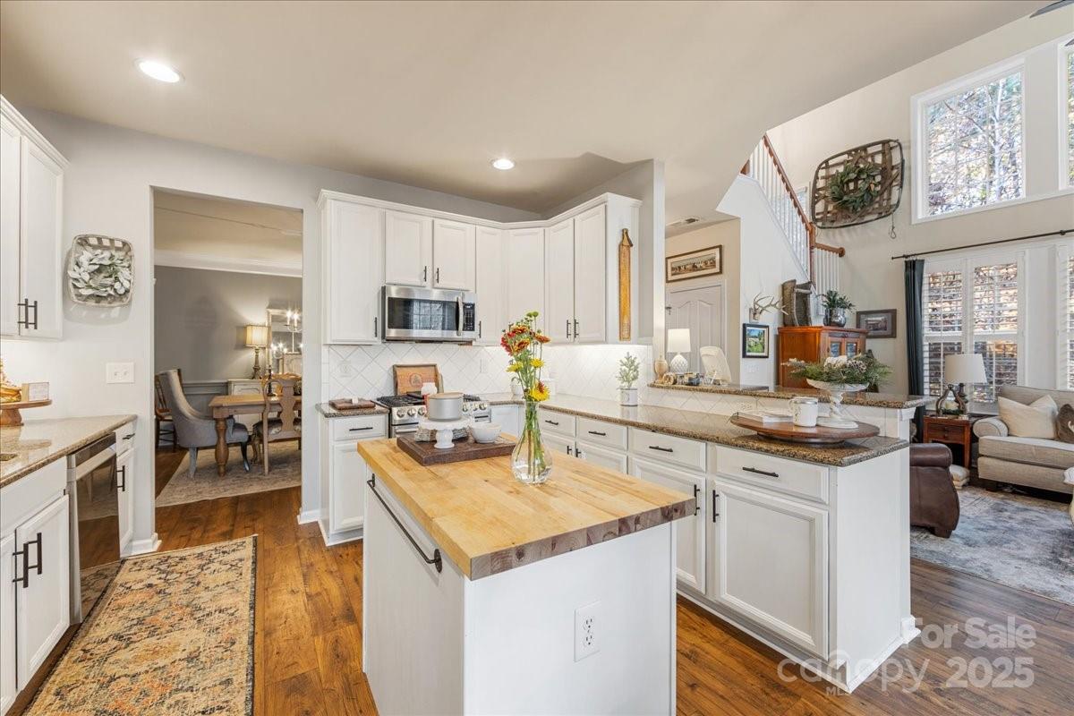 718 Deerbrook Lane Tega Cay, SC 29708 - Photo 19 of 45 a kitchen with stainless steel appliances granite countertop a sink and cabinets