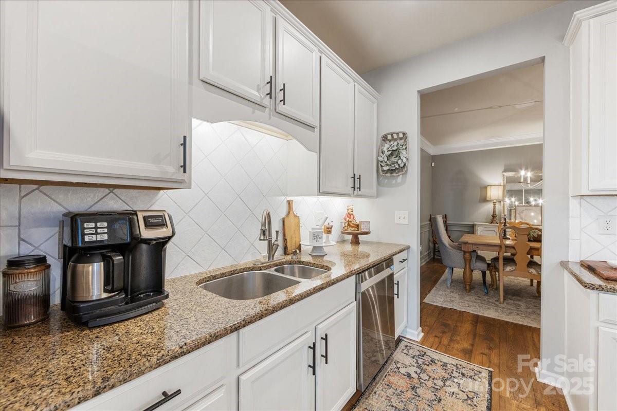718 Deerbrook Lane Tega Cay, SC 29708 - Photo 24 of 45 a kitchen with stainless steel appliances granite countertop a sink and a refrigerator