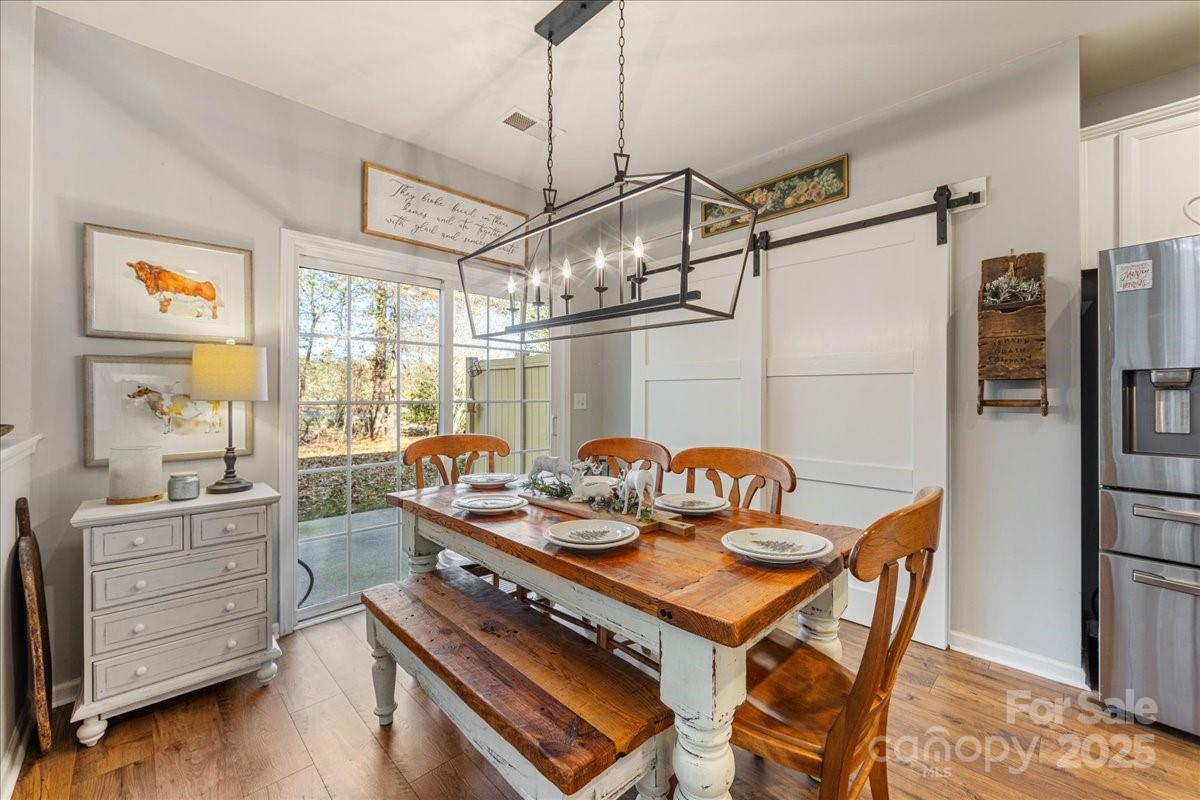 718 Deerbrook Lane Tega Cay, SC 29708 - Photo 26 of 45 a table and chairs in a room with wooden floor