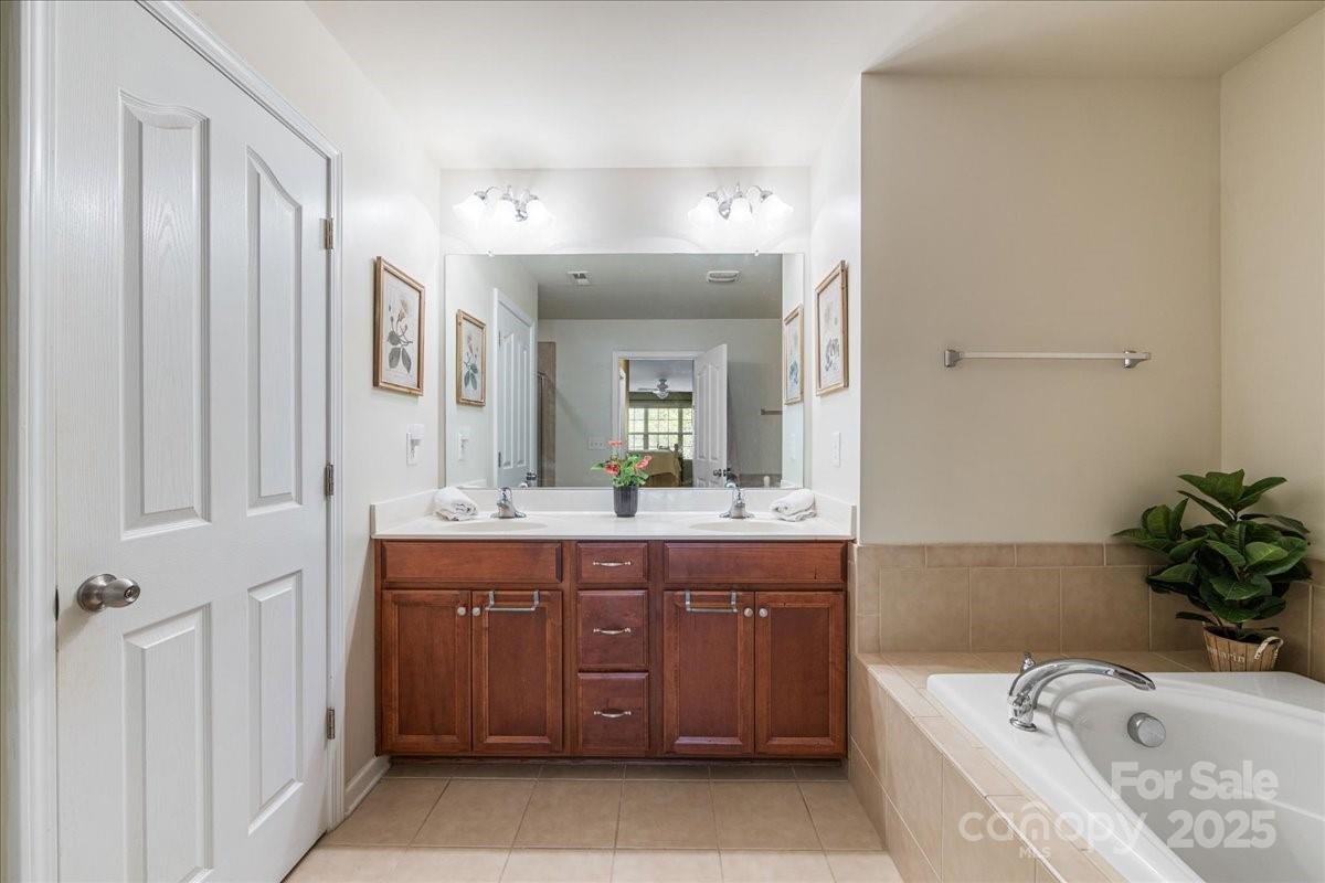 718 Deerbrook Lane Tega Cay, SC 29708 - Photo 33 of 45 a bathroom with a tub sink and mirror