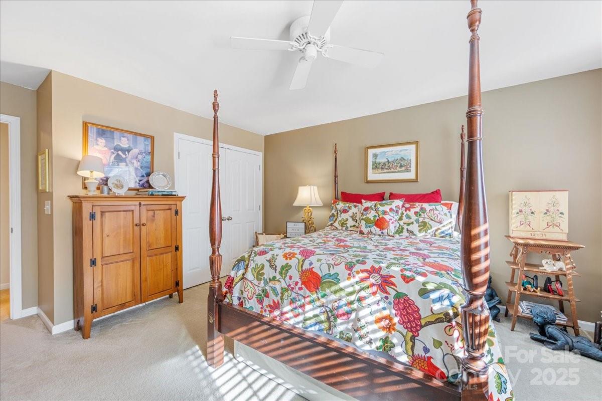 718 Deerbrook Lane Tega Cay, SC 29708 - Photo 40 of 45 a bedroom with bed and paintings on the wall