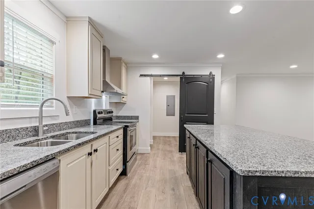 a kitchen with granite countertop a refrigerator and a sink