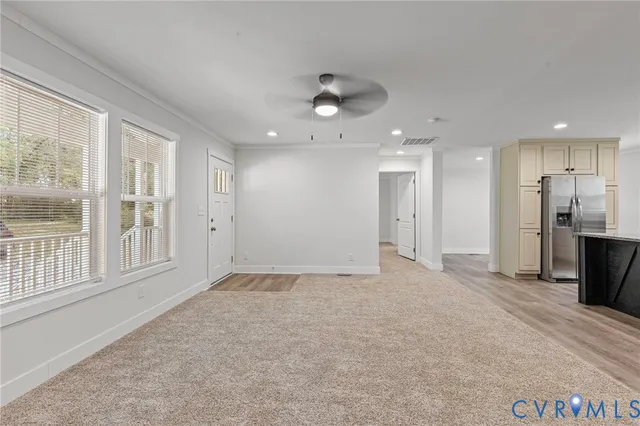 a view of an empty room with a kitchen