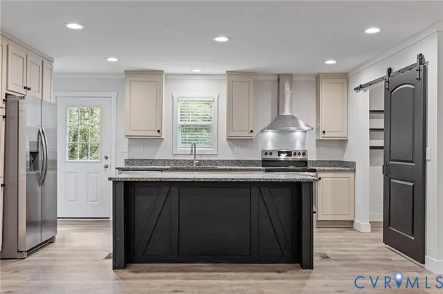 a kitchen with stainless steel appliances granite countertop a sink a stove a refrigerator and cabinets