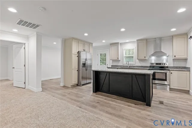 a kitchen with stainless steel appliances granite countertop a refrigerator and a sink