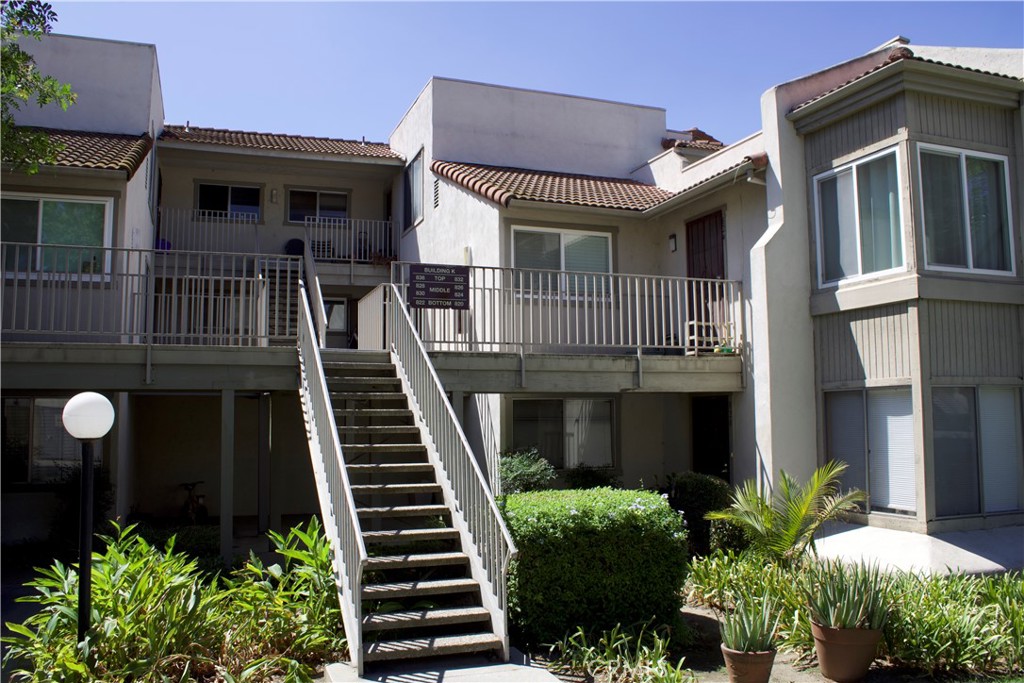 a front view of a house with plants