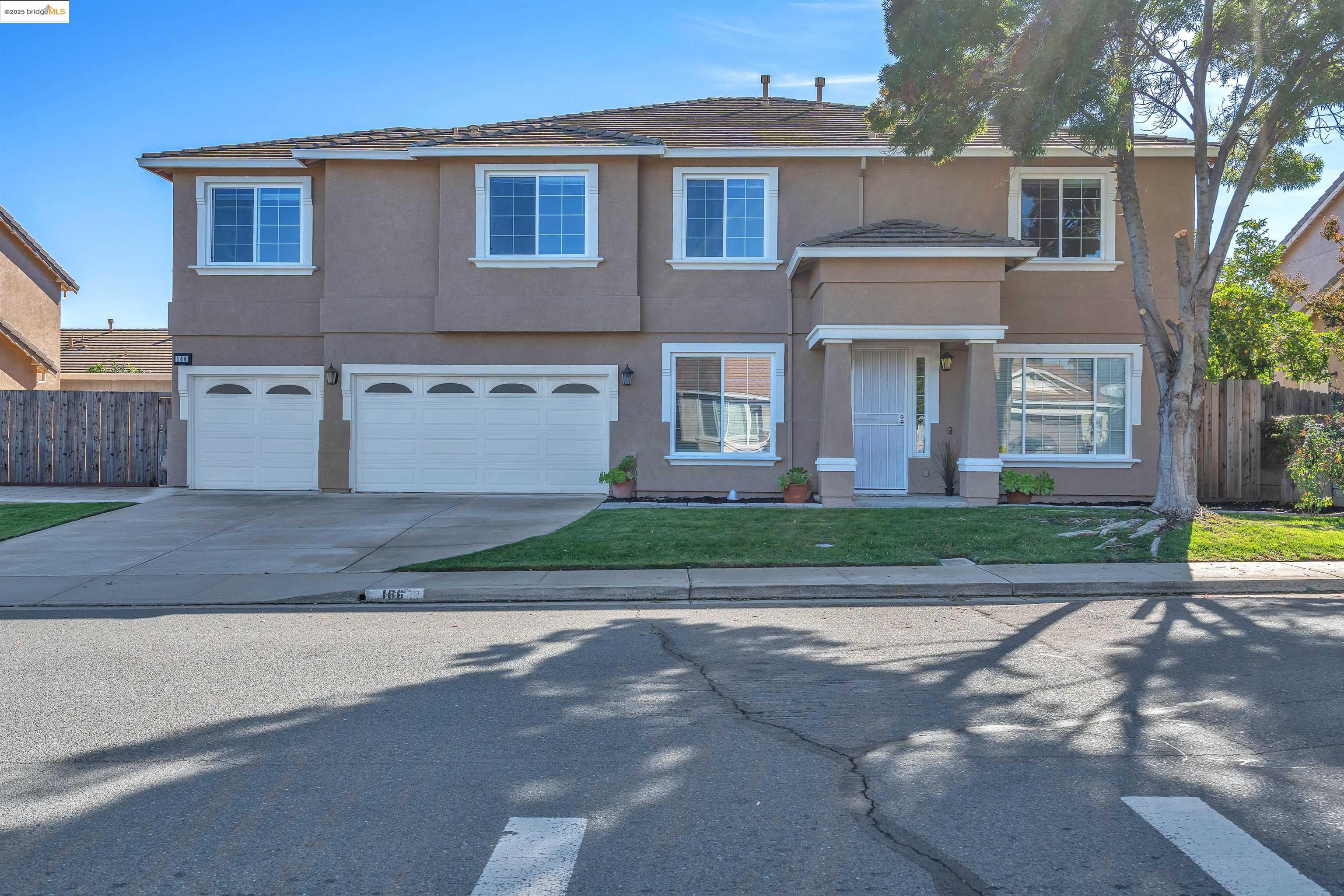 a front view of a house with a yard and a garage