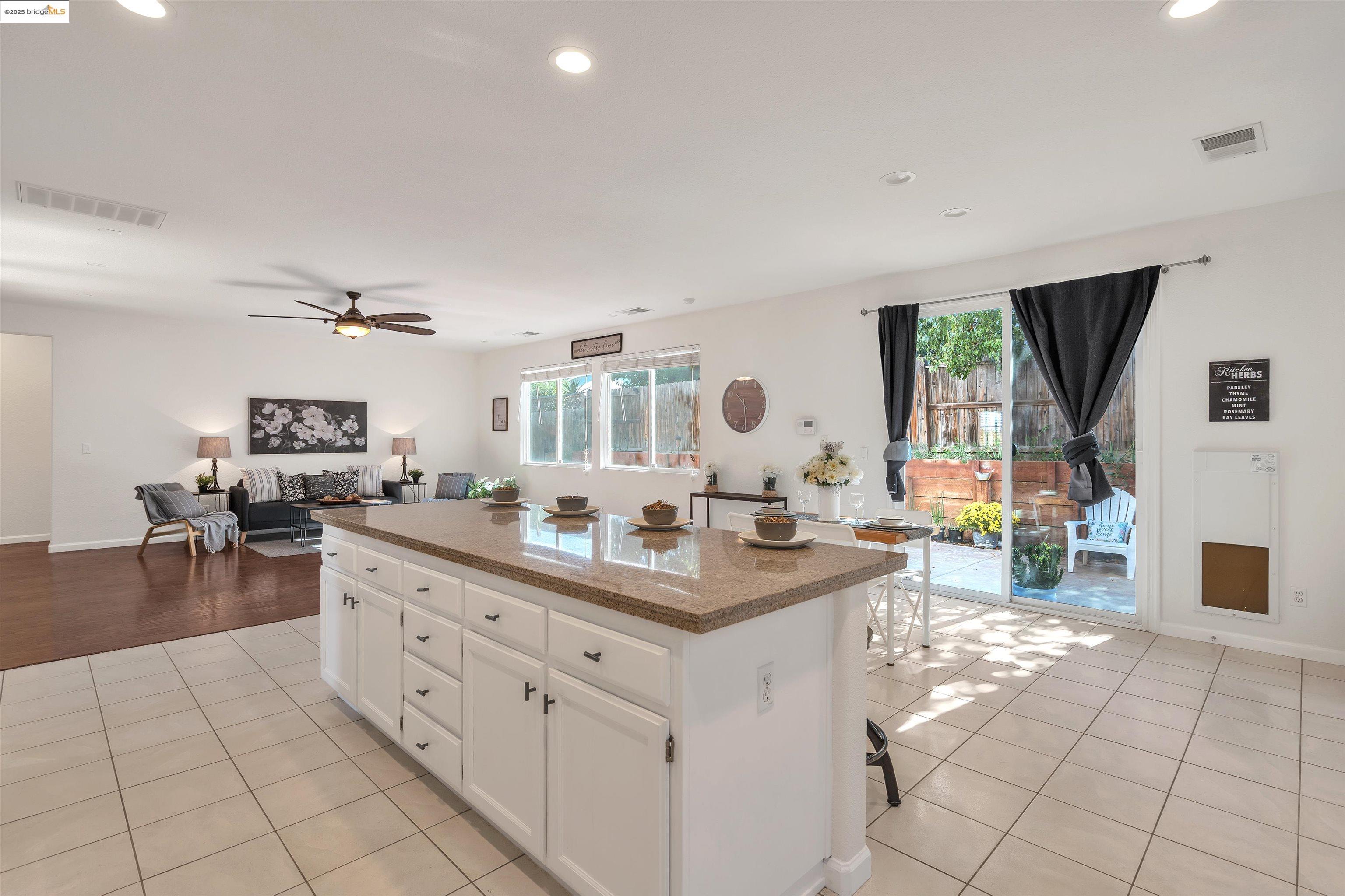 166 Rangewood Drive Pittsburg, CA 94565 - Photo 11 of 42 a living room with furniture a flat screen tv and a table