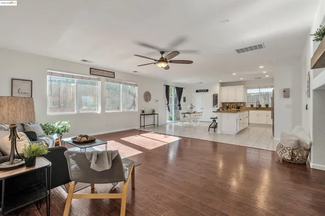 a living room with dining room and wooden floor