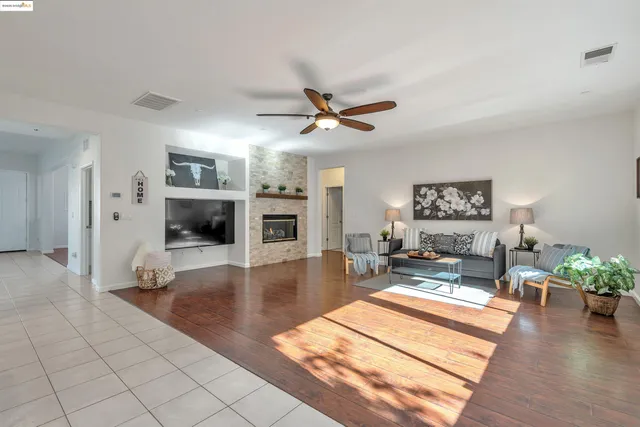 a living room with furniture flat screen tv and a fireplace
