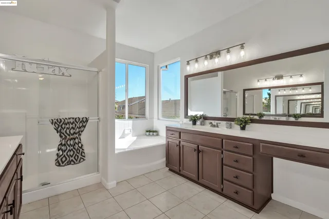 a spacious bathroom with a sink a mirror and a bathtub
