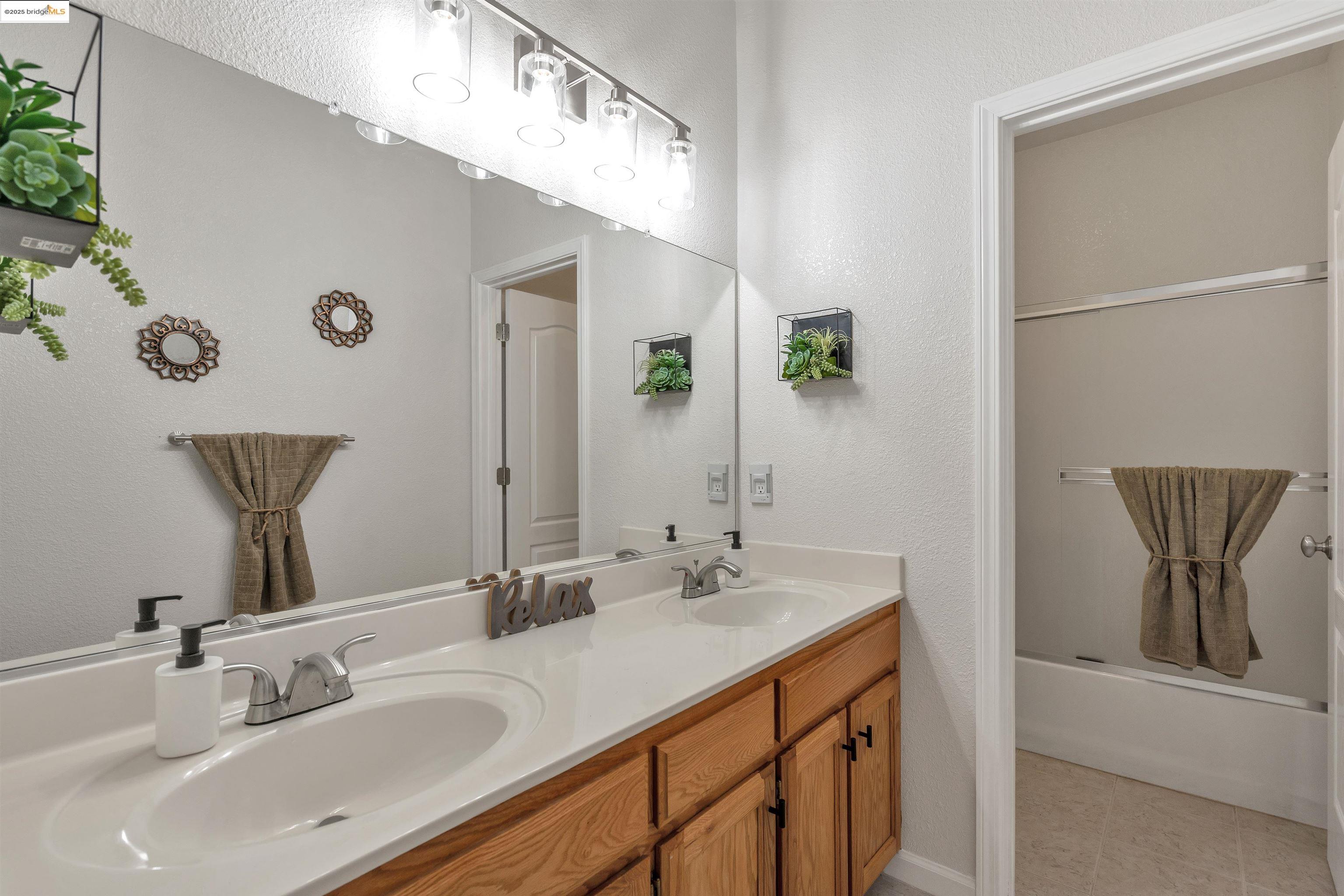 166 Rangewood Drive Pittsburg, CA 94565 - Photo 34 of 42 a bathroom with a double vanity sink and a mirror