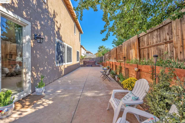 a backyard of a house with table and chairs