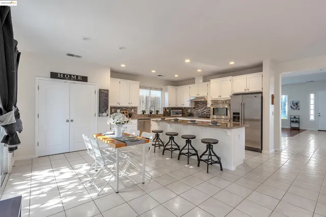 a view of a kitchen with dining room and wooden floor