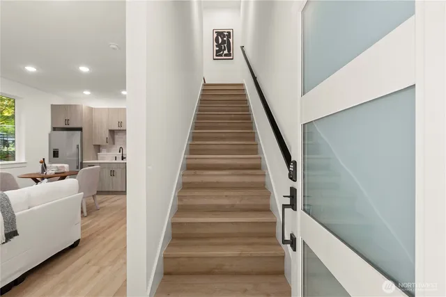 a living room with furniture and a view of kitchen