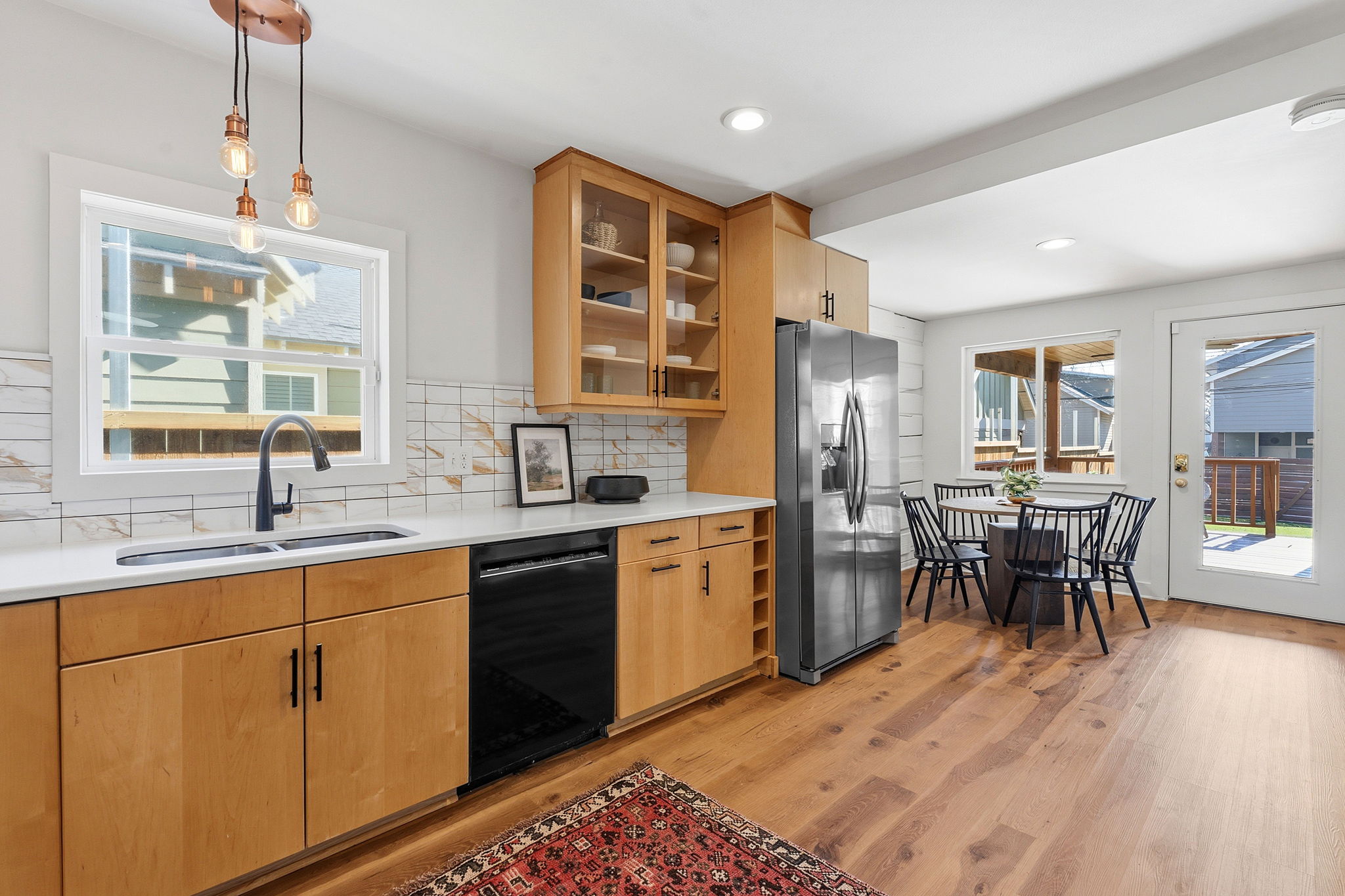 5509 Avenue F Austin, TX 78751 - Photo 17 of 40 The kitchen comes wrapped in generous contemporary, ceiling height cabinetry with a windows over the kitchen sink.