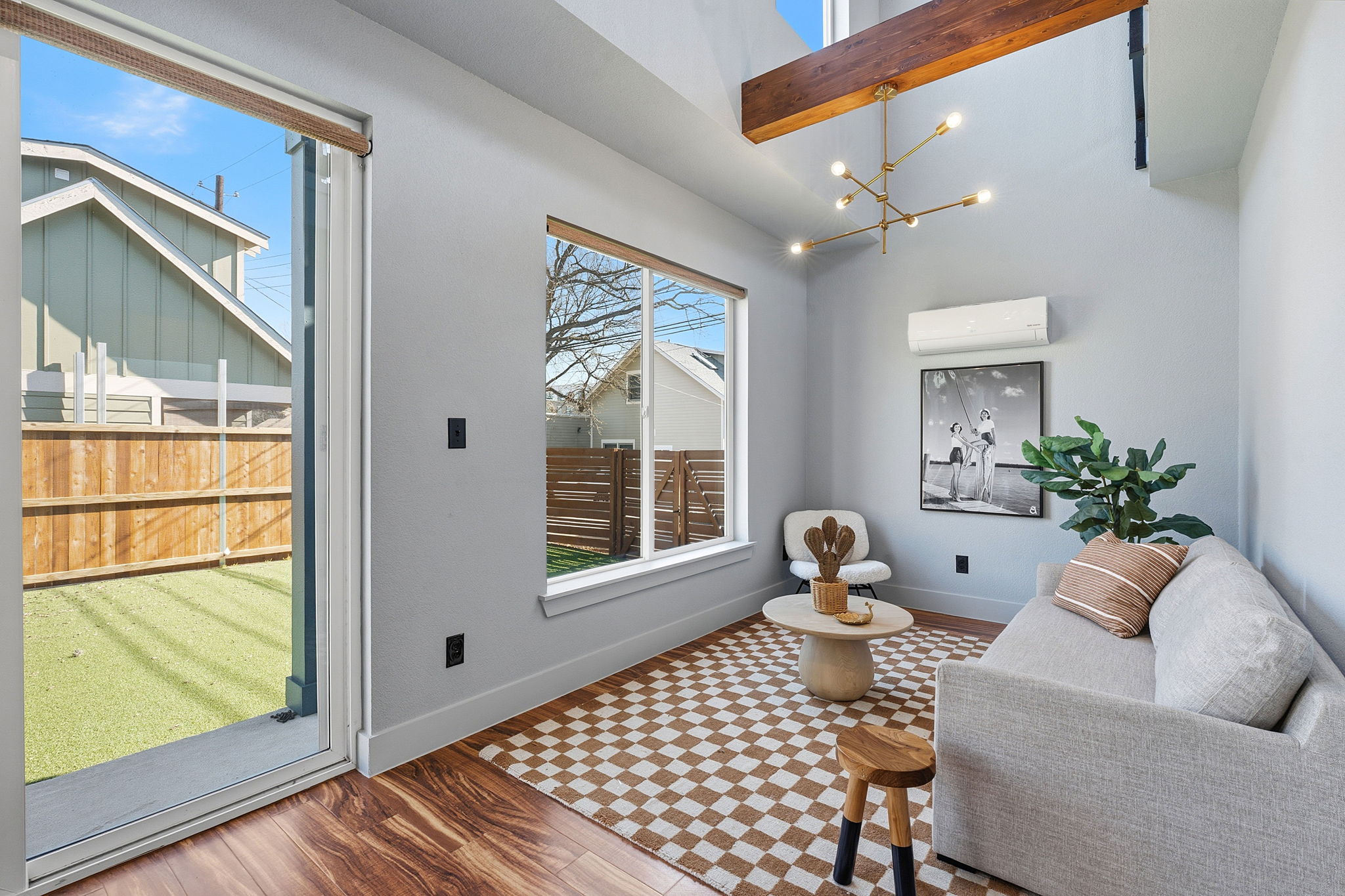 5509 Avenue F Austin, TX 78751 - Photo 26 of 40 Inside the back house you will find a cozy living room under soaring vaulted ceilings with picture windows overlooking the yard.