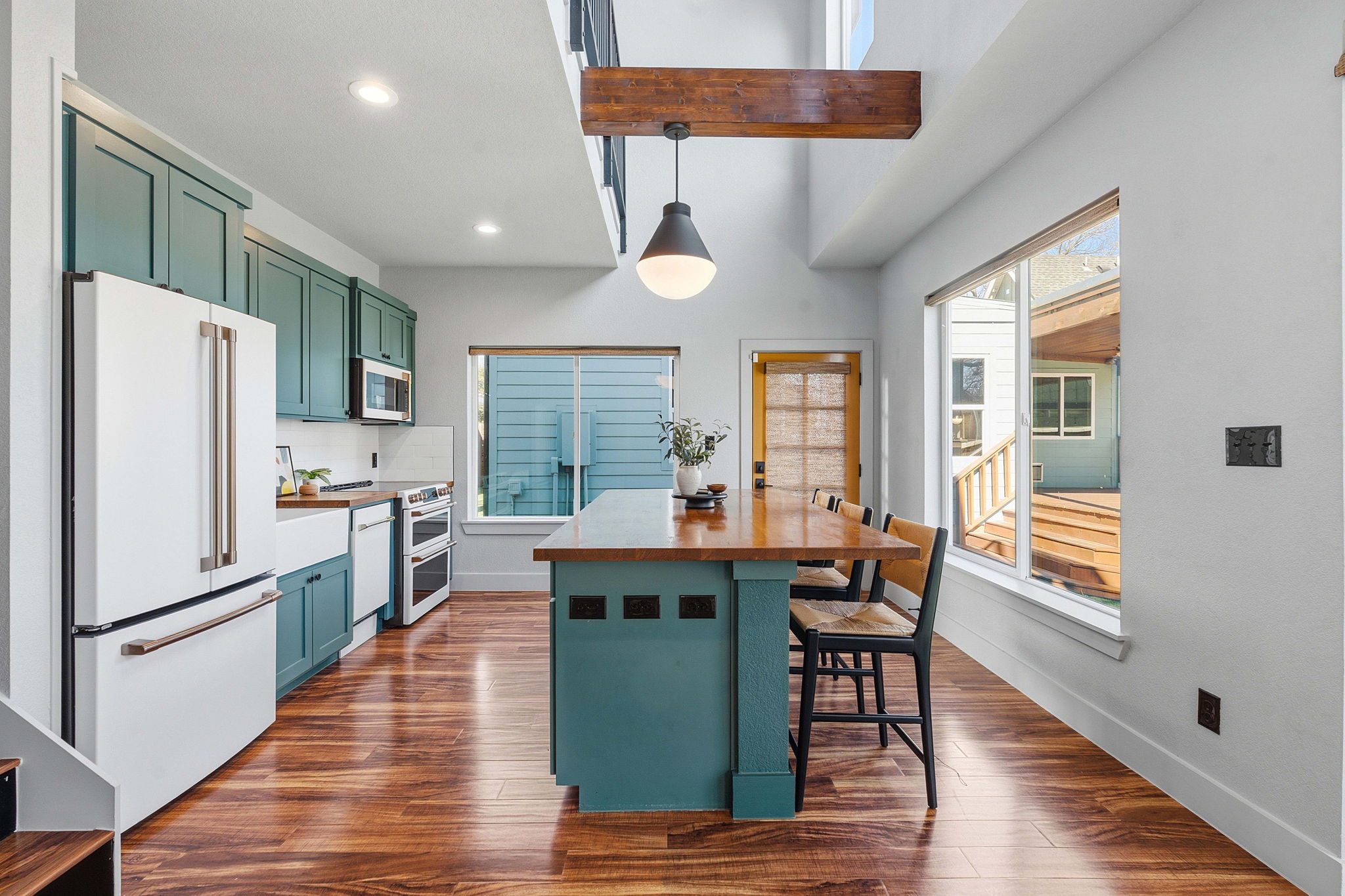 5509 Avenue F Austin, TX 78751 - Photo 29 of 40 Enjoy premium appliances, a farmhouse-style sink, subway tile backsplash, and contemporary cabinetry.