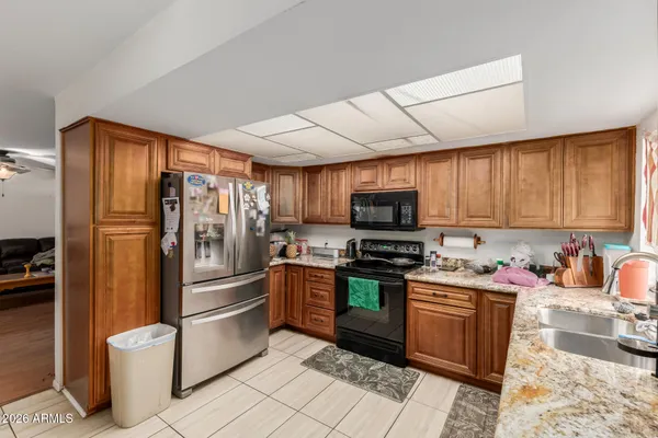 a kitchen with a sink window and stainless steel appliances
