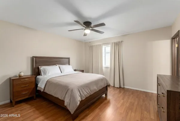 a bedroom with a bed and a ceiling fan