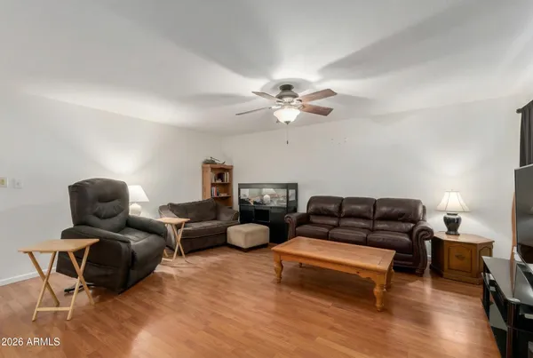 a living room with furniture a ceiling fan and a rug