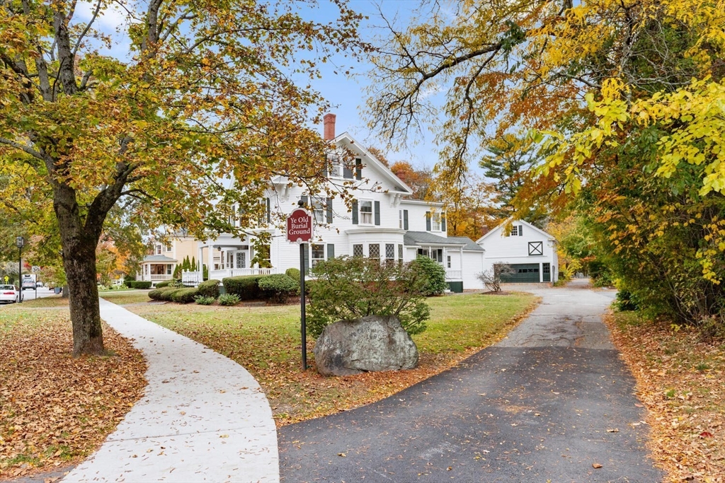 1949 Massachusetts Avenue Lexington, MA 02421 - Photo 6 of 11 a front view of a house with a garden and trees