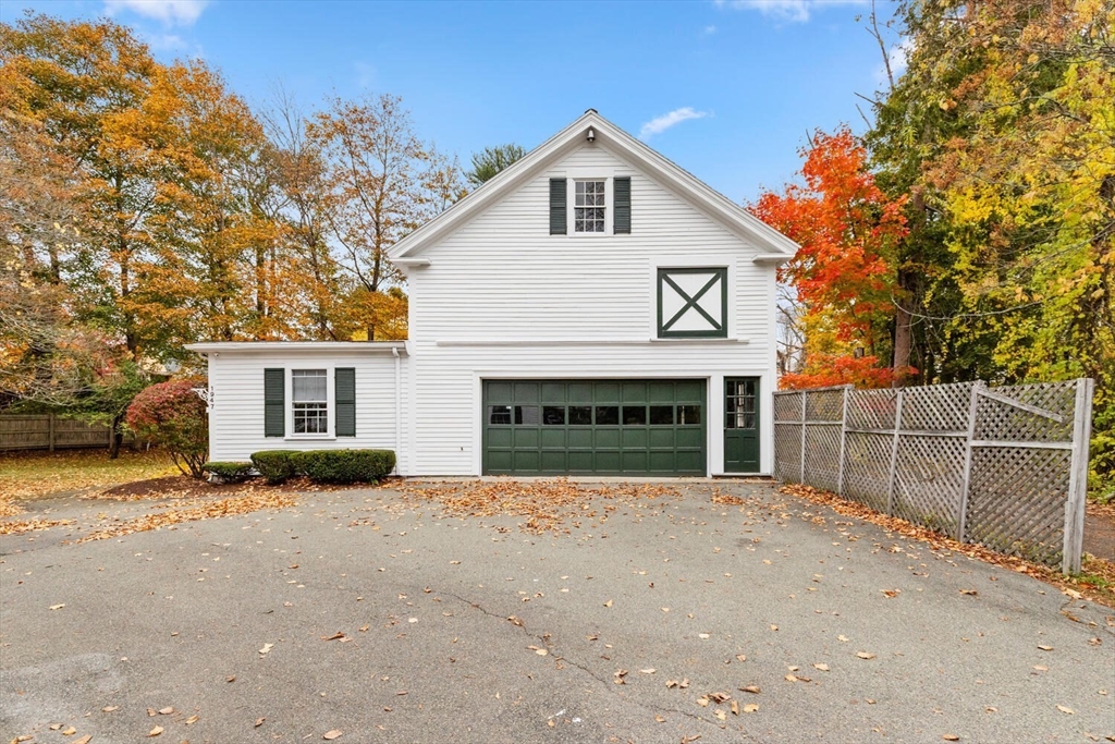 1949 Massachusetts Avenue Lexington, MA 02421 - Photo 7 of 11 a front view of a house with a yard and garage