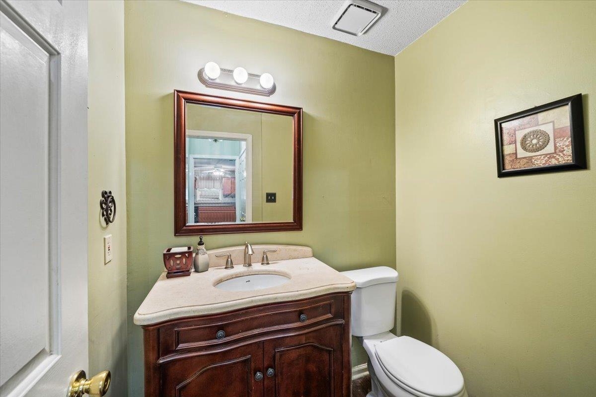 405 Dove Valley Road Collierville, TN 38017 - Photo 12 of 25 a bathroom with a granite countertop toilet sink and mirror