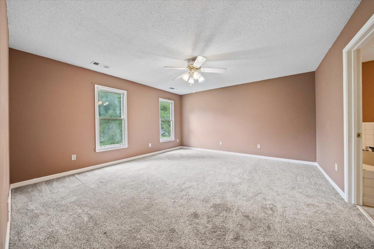 405 Dove Valley Road Collierville, TN 38017 - Photo 13 of 25 an empty room with windows and chandelier fan