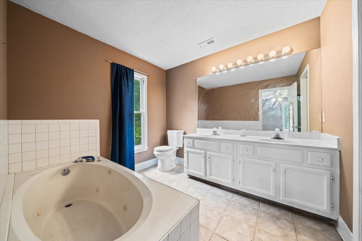 405 Dove Valley Road Collierville, TN 38017 - Photo 14 of 25 a bathroom with a sink and a large mirror