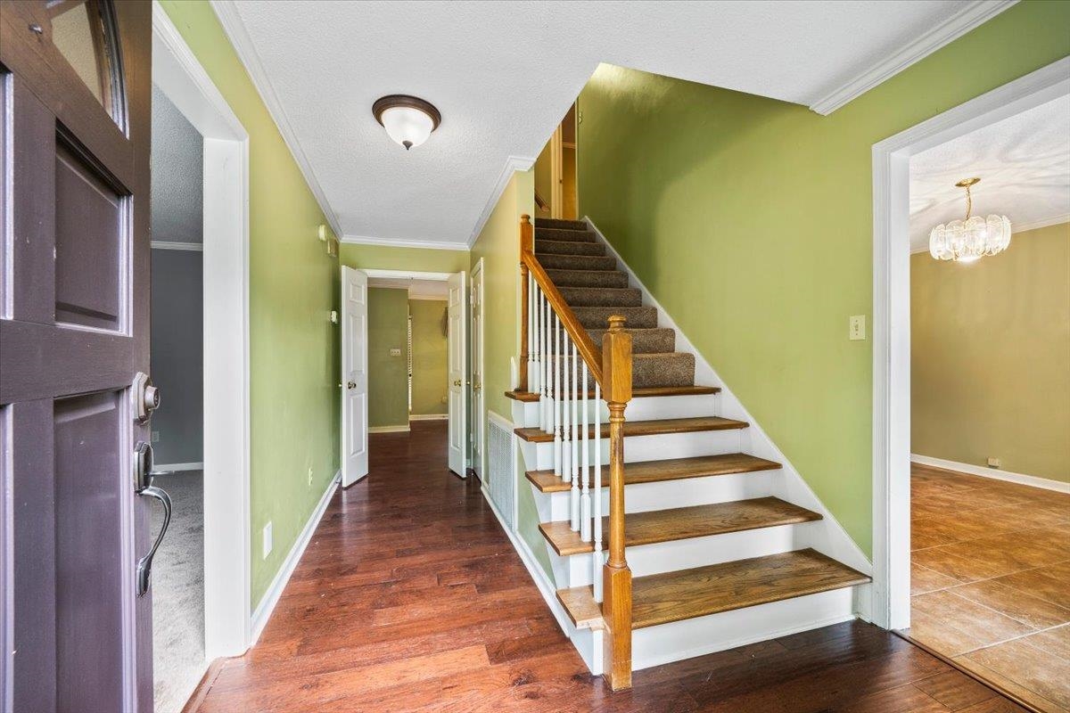 405 Dove Valley Road Collierville, TN 38017 - Photo 2 of 25 a view of a hallway with wooden floor and staircase