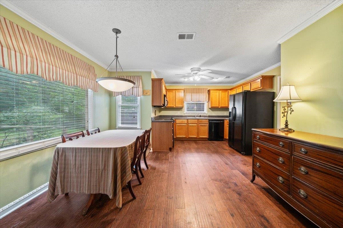 405 Dove Valley Road Collierville, TN 38017 - Photo 7 of 25 a kitchen with a table chairs refrigerator and cabinets
