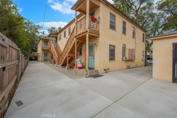 a view of a house with a wooden fence