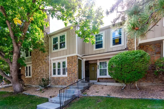 a view of house with a backyard