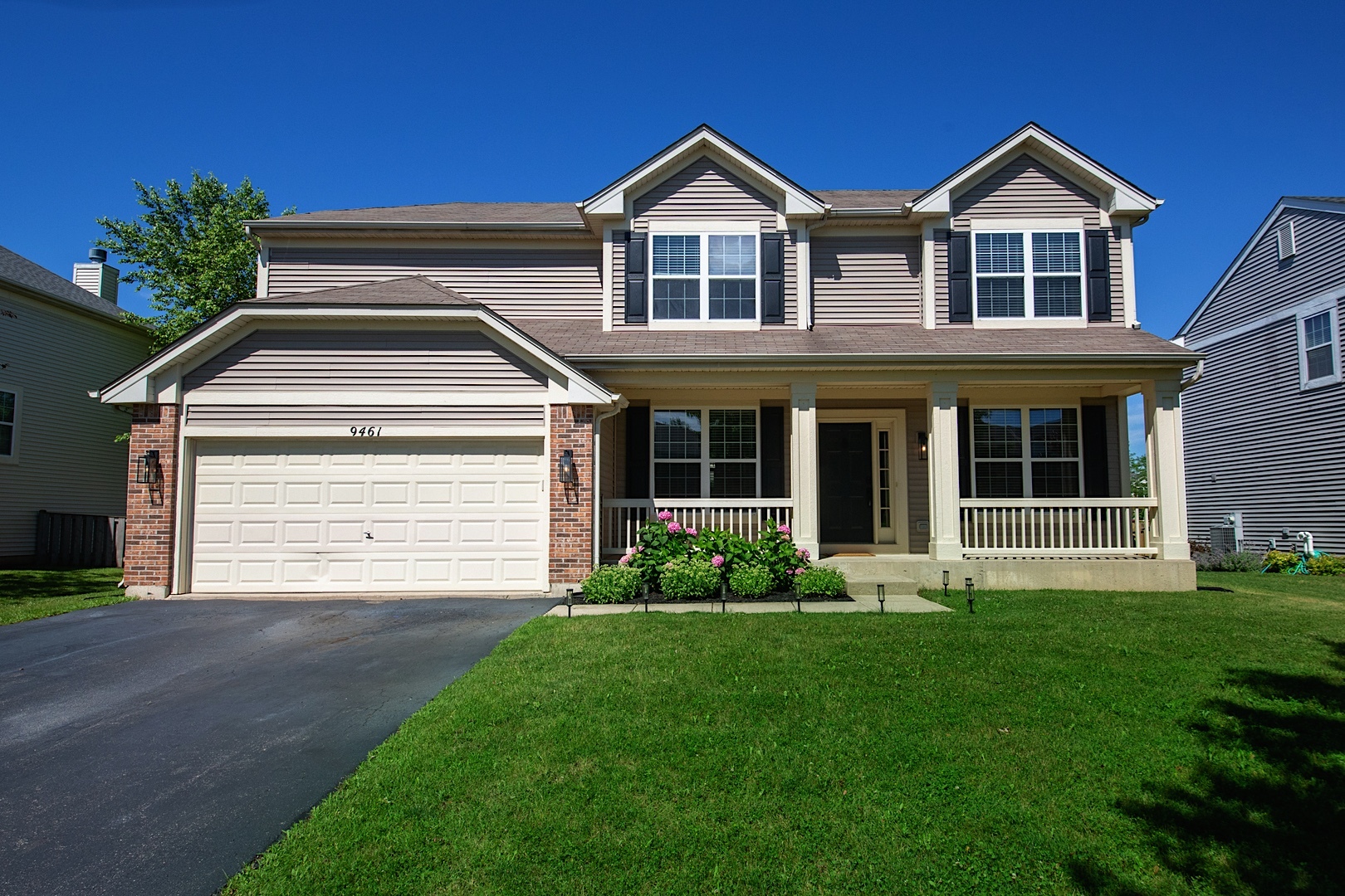 a front view of a house with a yard and garage