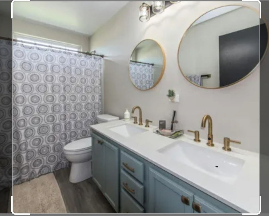 9461 Welsh Lane Huntley, IL 60142 - Photo 13 of 19 a bathroom with a toilet a sink and mirror