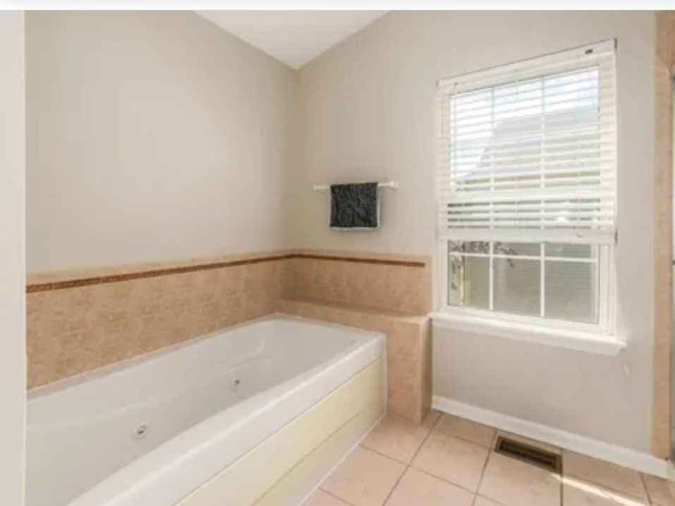 9461 Welsh Lane Huntley, IL 60142 - Photo 15 of 19 a bathroom with a bathtub and a window