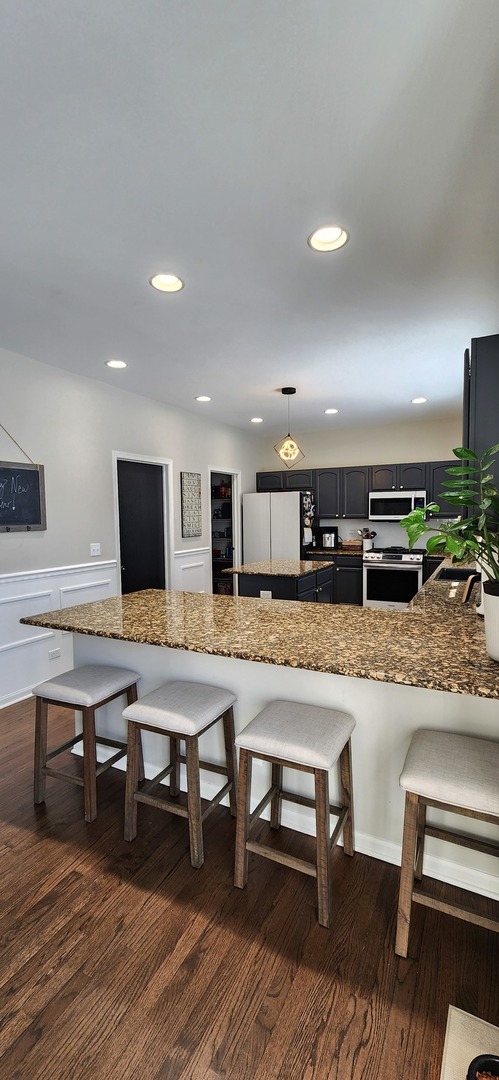 9461 Welsh Lane Huntley, IL 60142 - Photo 9 of 19 a living room with stainless steel appliances furniture and a kitchen view