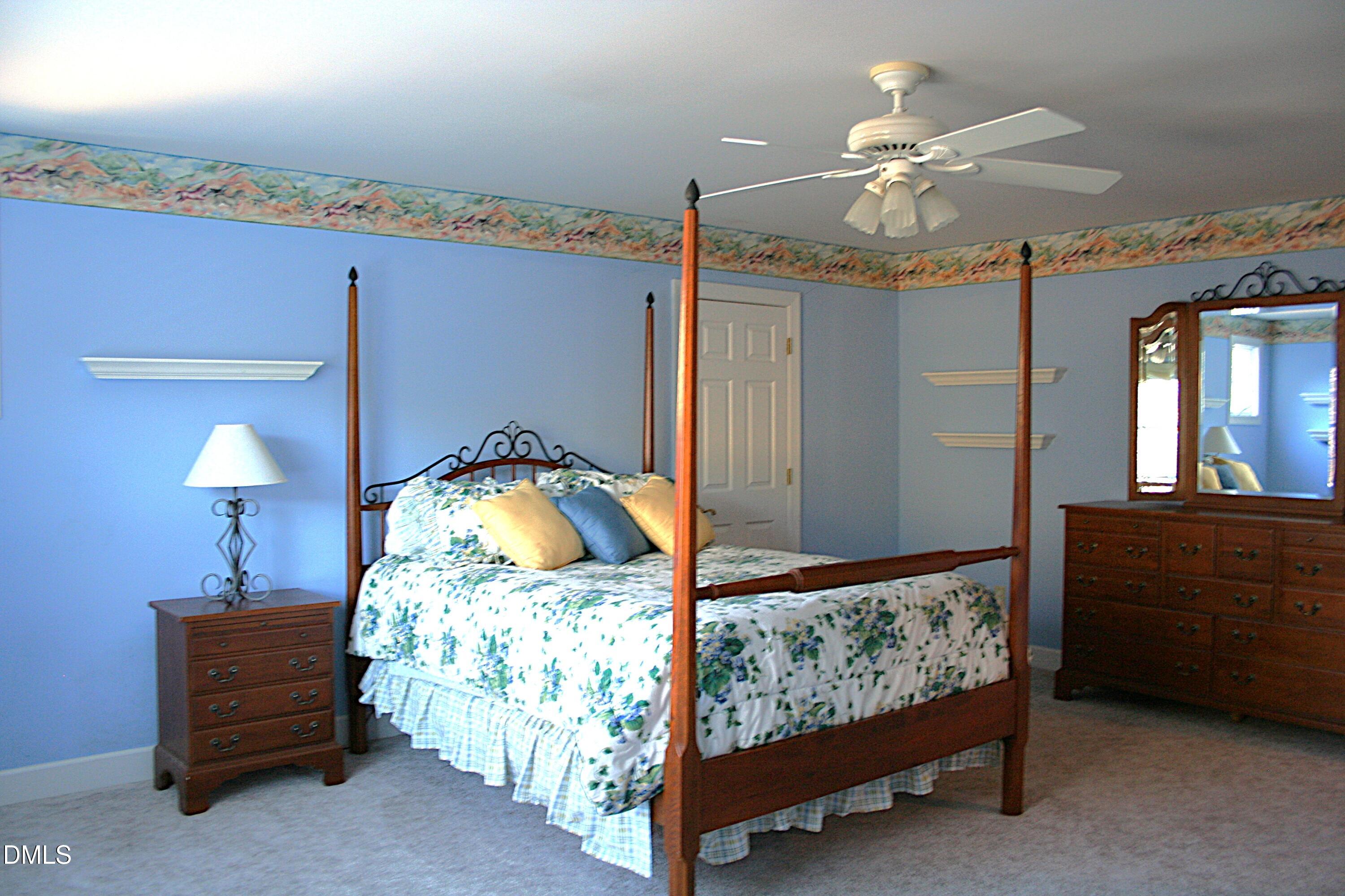 220 Jordan Narron Road Selma, NC 27576 - Photo 47 of 87 a bedroom with a bed and a chandelier