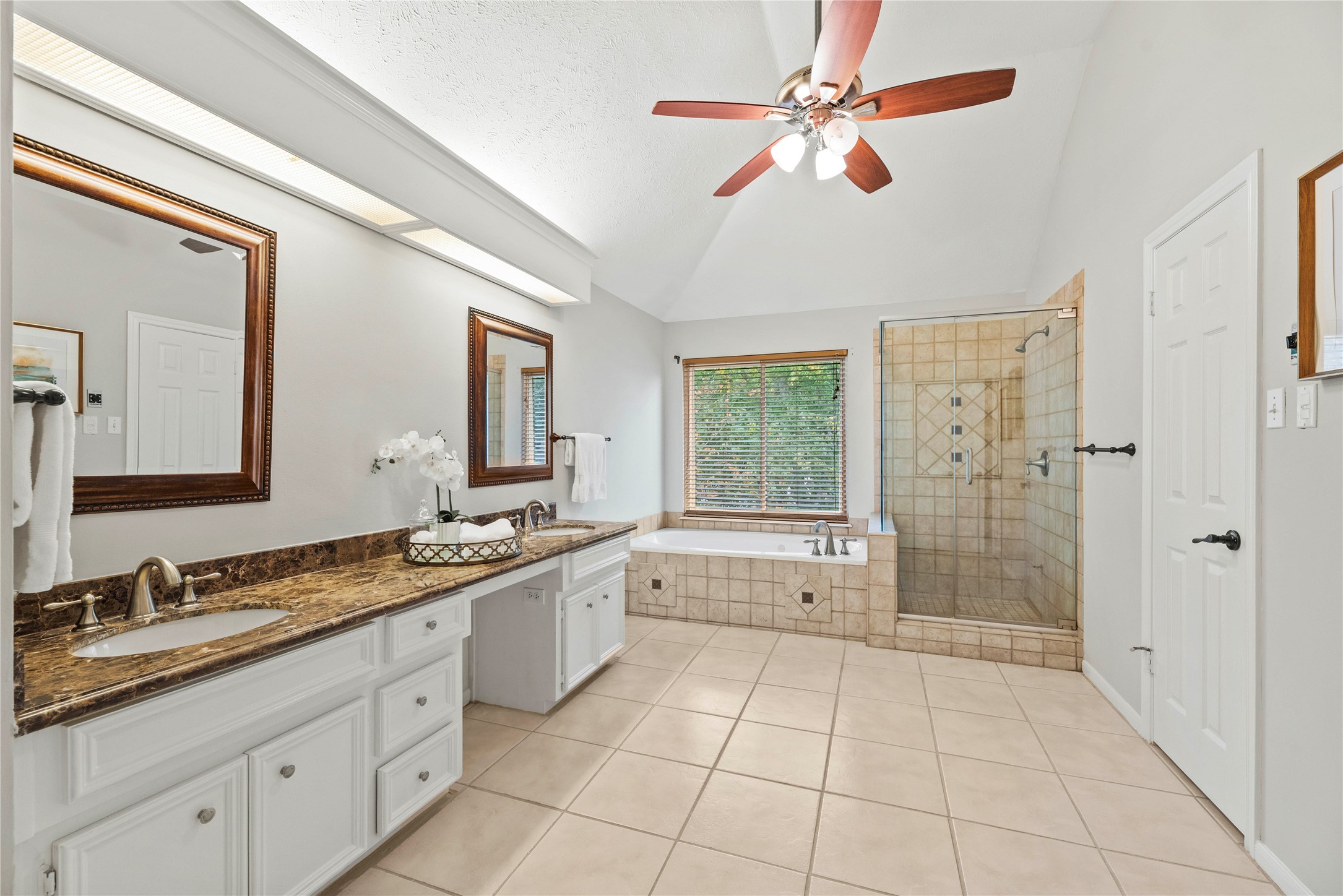 7403 Foxton Pl Court Houston, TX 77095 - Photo 21 of 41 This spa-like ensuite bathroom adds a daily dose of luxury to your routine, featuring tile flooring, high ceilings, and a thoughtful layout that blends style with functionality for everyday comfort.