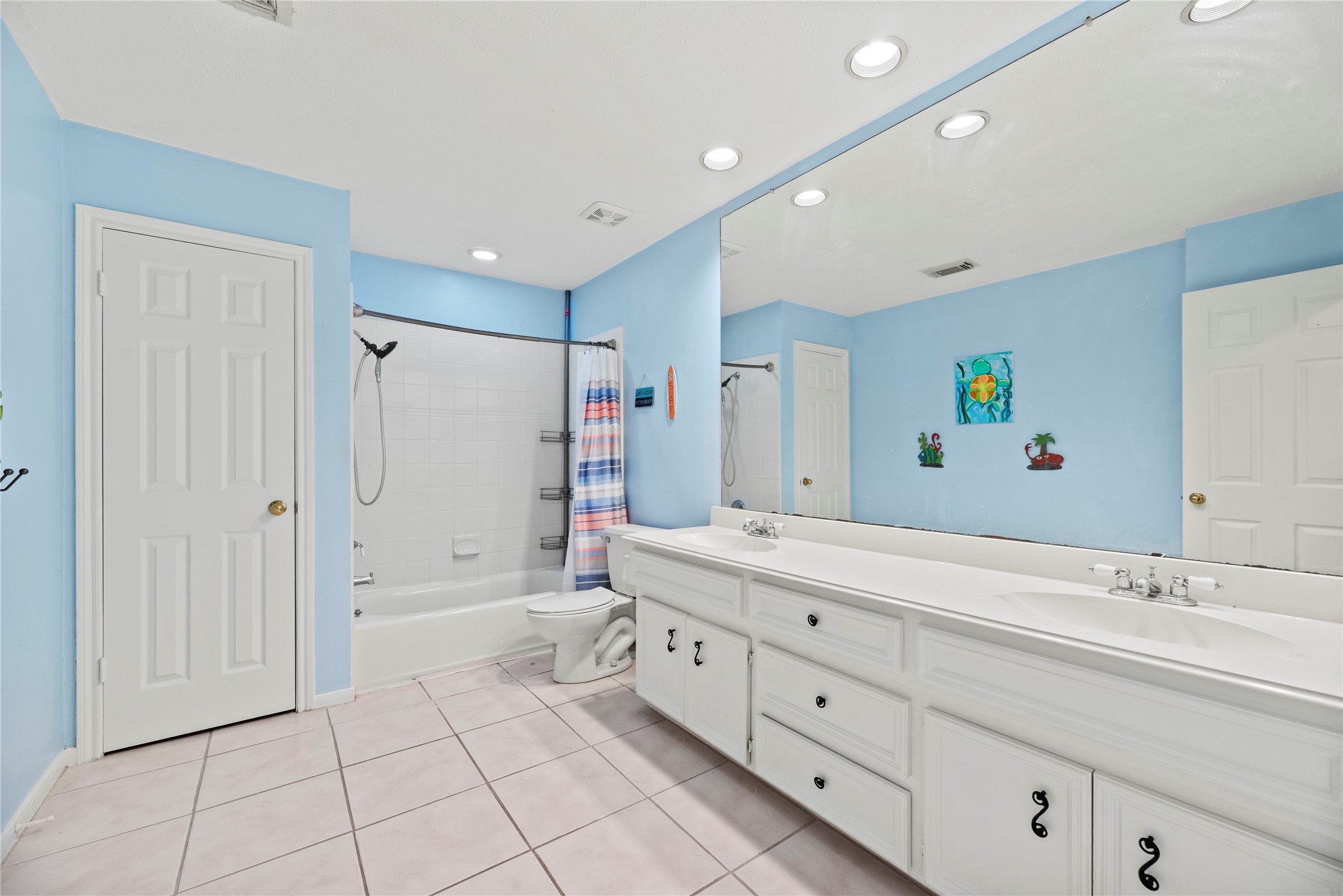 7403 Foxton Pl Court Houston, TX 77095 - Photo 26 of 41 This upstairs guest bathroom is thoughtfully designed with an expansive dual sink vanity, a private water closet, and a fully tiled tub and shower combination, creating a spacious layout that is easy to share.