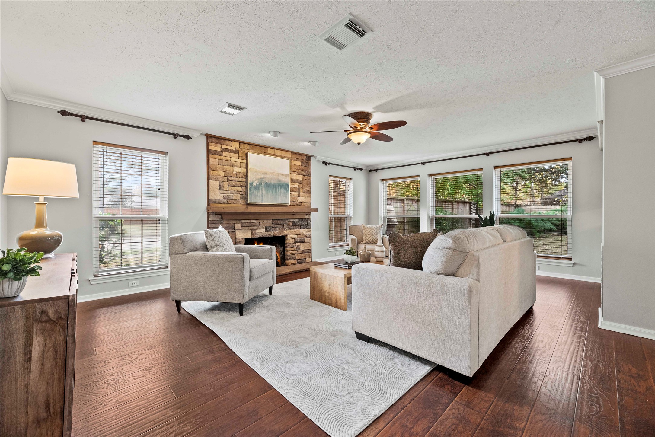 7403 Foxton Pl Court Houston, TX 77095 - Photo 3 of 41 The family room is anchored by a striking stone fireplace with a rich wood mantel, creating a warm focal point for both relaxing evenings in and gatherings with family and friends.