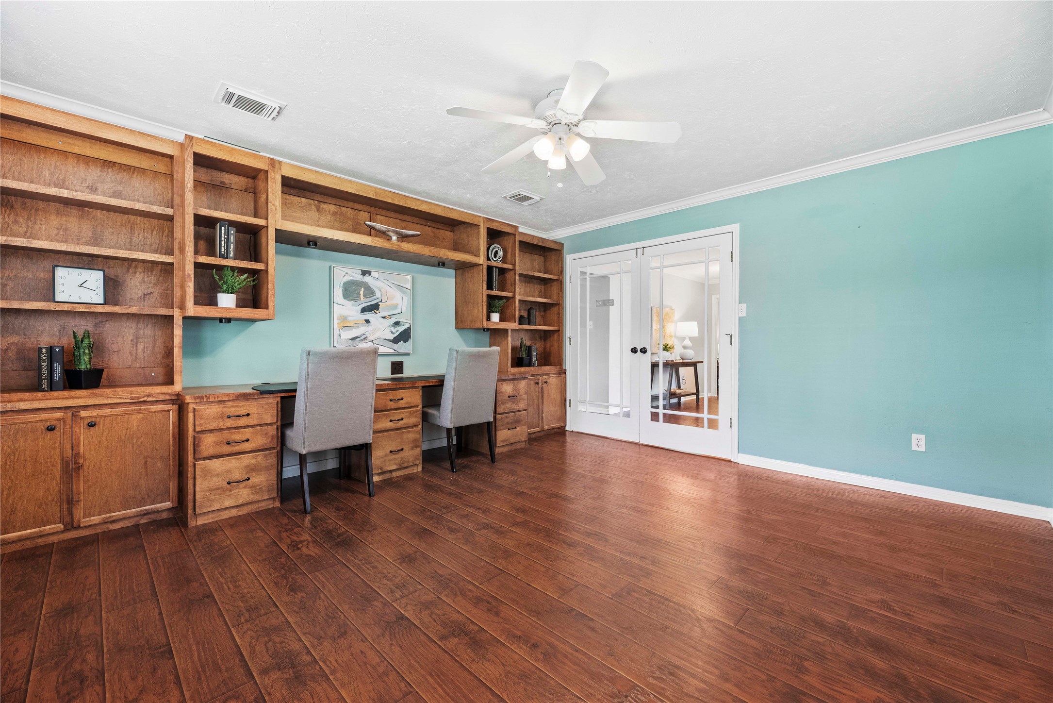 7403 Foxton Pl Court Houston, TX 77095 - Photo 7 of 41 Custom built-ins provide the perfect setup to work from home, with abundant storage and desk space while the roomy layout and natural light make this room equally suited for an alternate living space or creative studio.