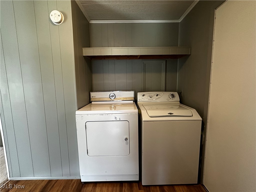 12921 Springfield Road, Unit 12S New Springfield, OH 44443 - Photo 9 of 25 Laundry room with hardwood / wood-style flooring, washer and clothes dryer, and a textured ceiling