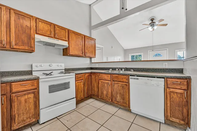 a kitchen with stainless steel appliances granite countertop a sink and cabinets