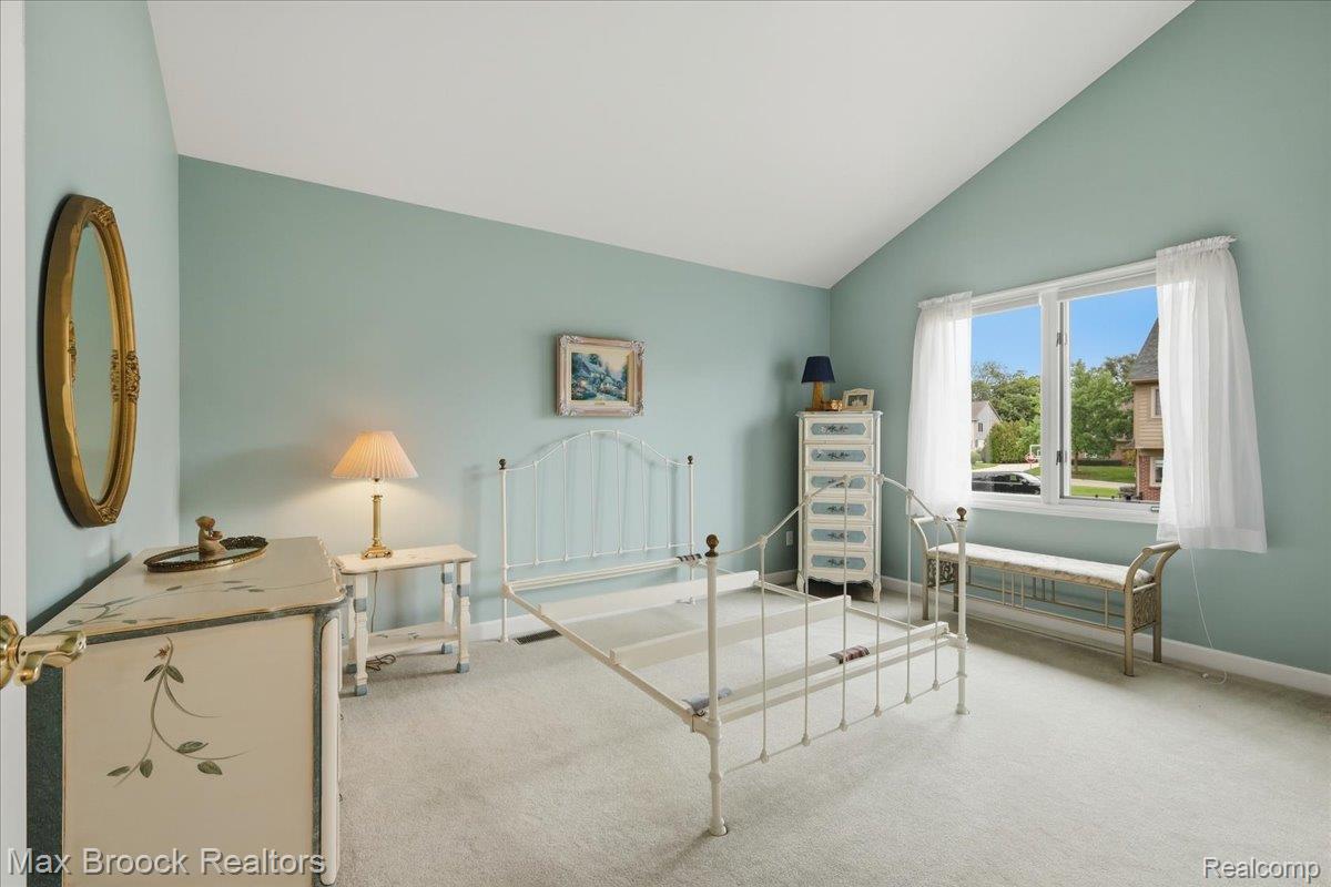 1731 Rico Road Commerce Township, MI 48382 - Photo 31 of 48 Vaulted ceiling, wall-to-wall carpeting, expansive window, light blue wall finishes, and white trim