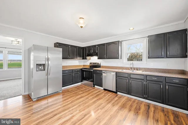a view of a room with wooden floor and white walls
