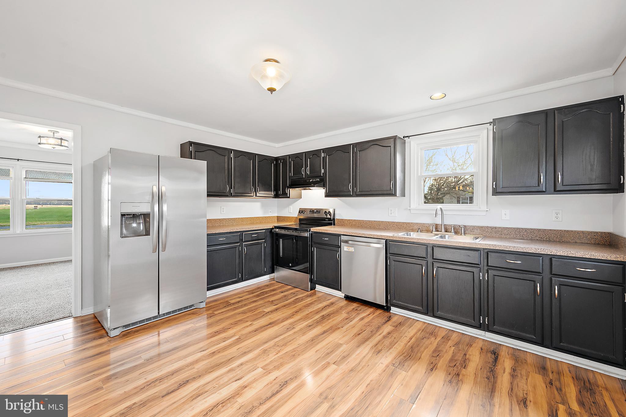 26792 Porter Mill Road Hebron, MD 21830 - Photo 11 of 91 a kitchen with stainless steel appliances granite countertop a refrigerator sink and cabinets