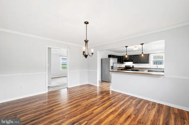 a bathroom with a granite countertop sink mirror vanity and toilet