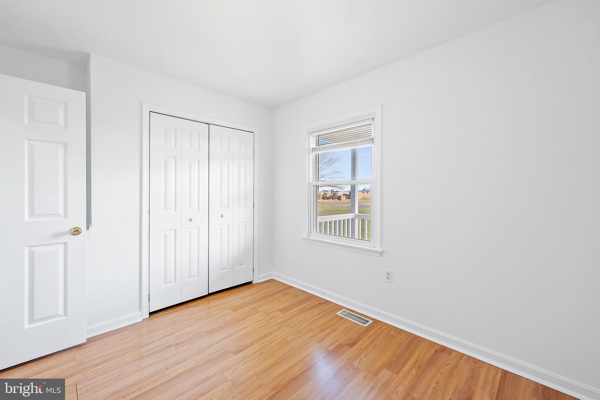26792 Porter Mill Road Hebron, MD 21830 - Photo 23 of 91 a view of an empty room with wooden floor and a window